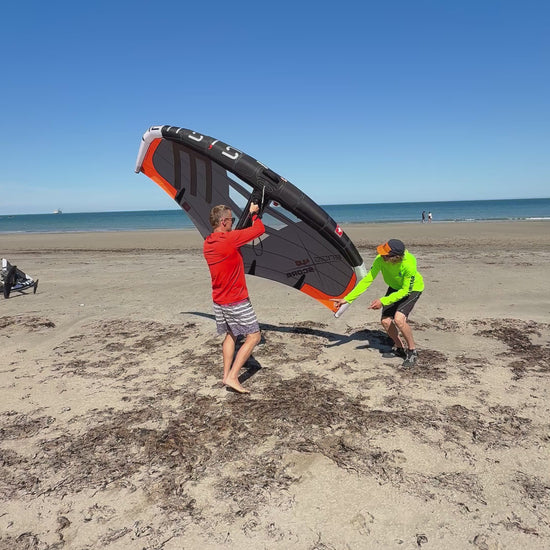 Surf Summit instructor with students teaching Wing handling on beach North Wales Crystal Clearwater