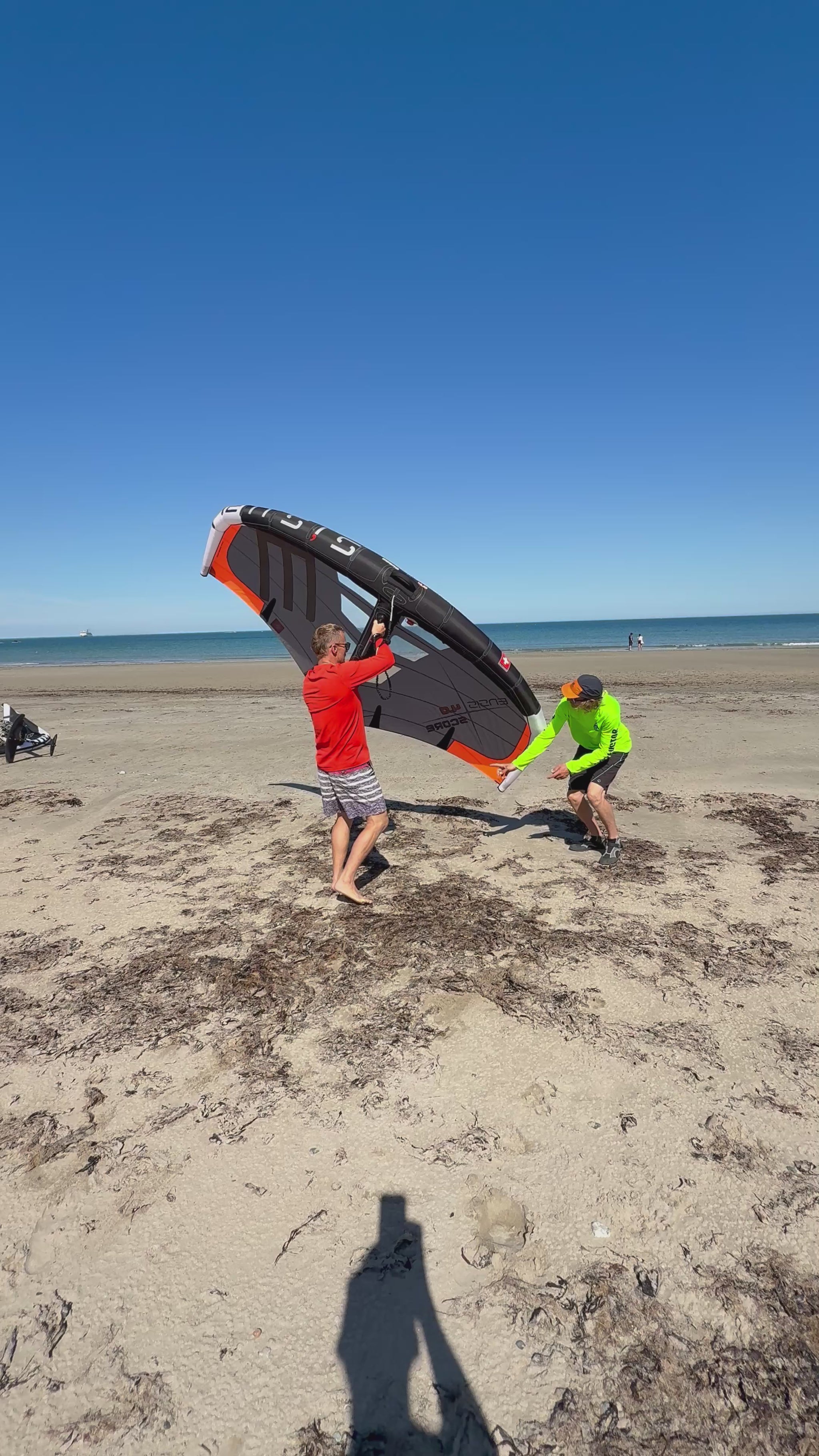 Surf Summit instructor with students teaching Wing handling on beach North Wales Crystal Clearwater