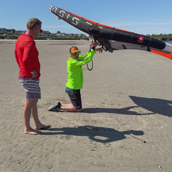 Surf to Summit instructor demonstrating Wing handling on beach North Wales before to Foil lesson