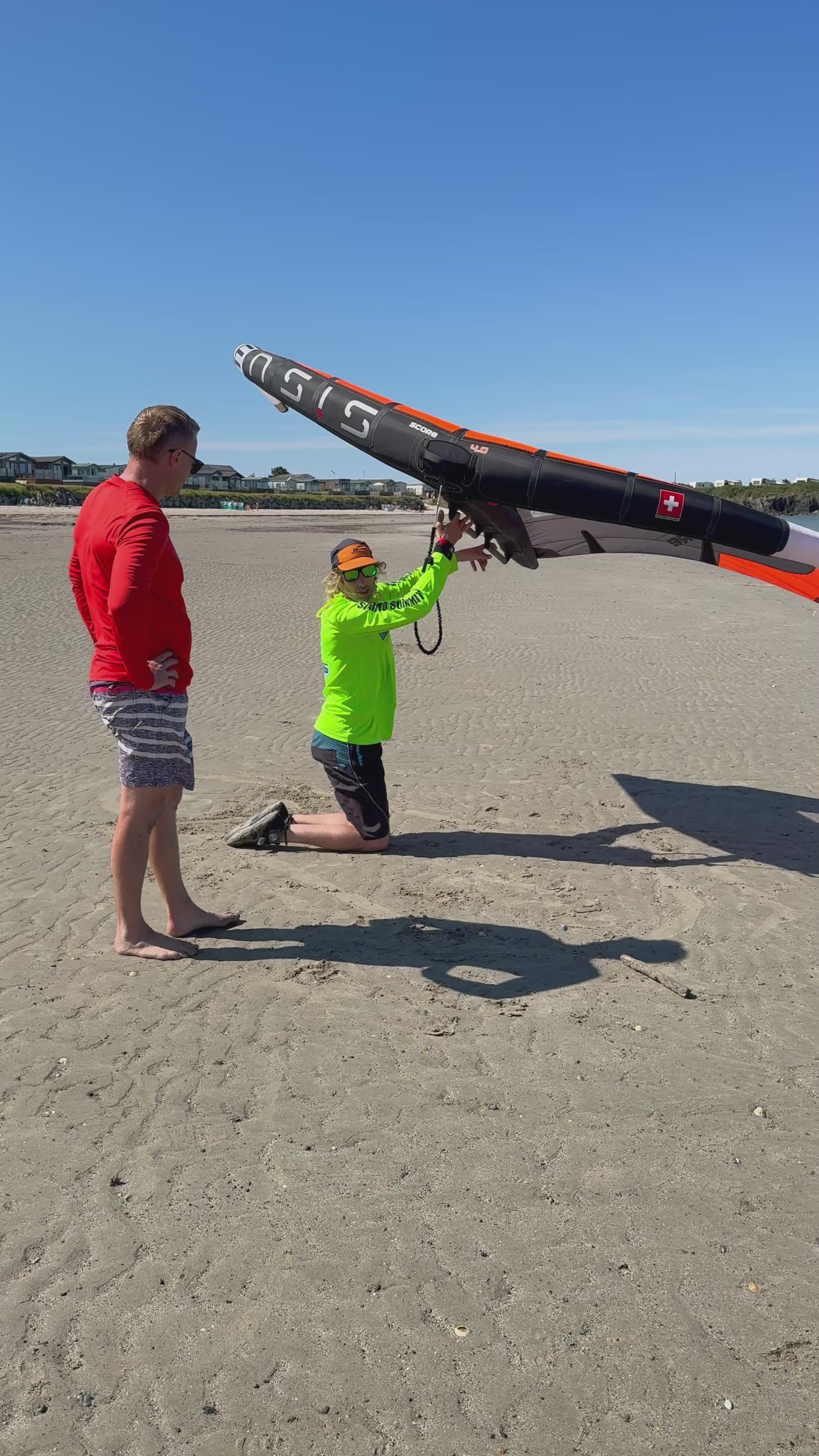 Surf to Summit instructor demonstrating Wing handling on beach North Wales before to Foil lesson