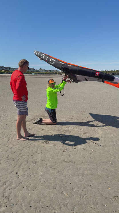 Surf to Summit instructor demonstrating Wing handling on beach North Wales before to Foil lesson