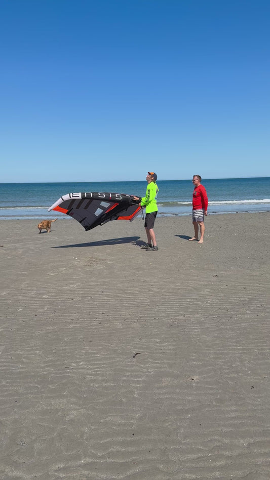 Understanding how the Wing works with hydrofoil to foiling instructor safe to summit with student on beach